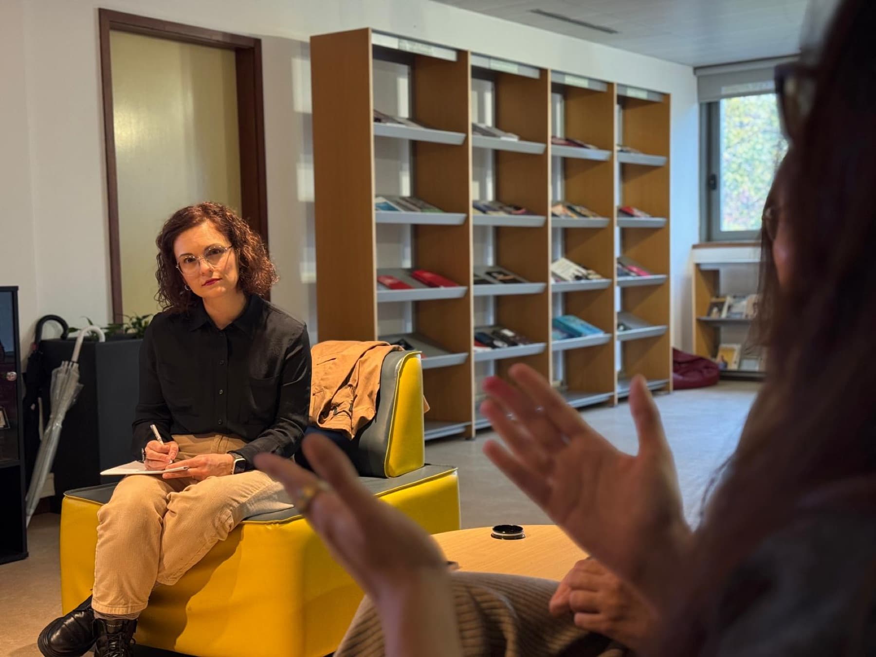 Elisa Gamba taking notes during a conversation with a client