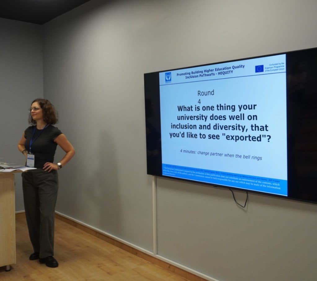 Elisa Gamba during the HEQUITY training at Sakarya University, standing next to a slide with a discussion question for participants
