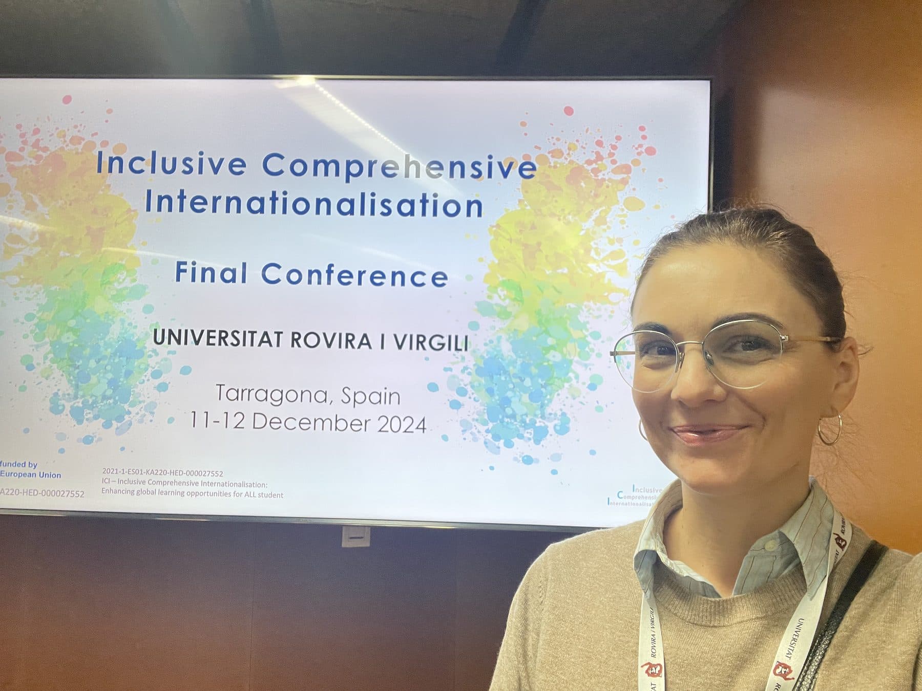 Elisa Gamba at the ICI project final conference in Tarragona, December 2024, beside the event slide